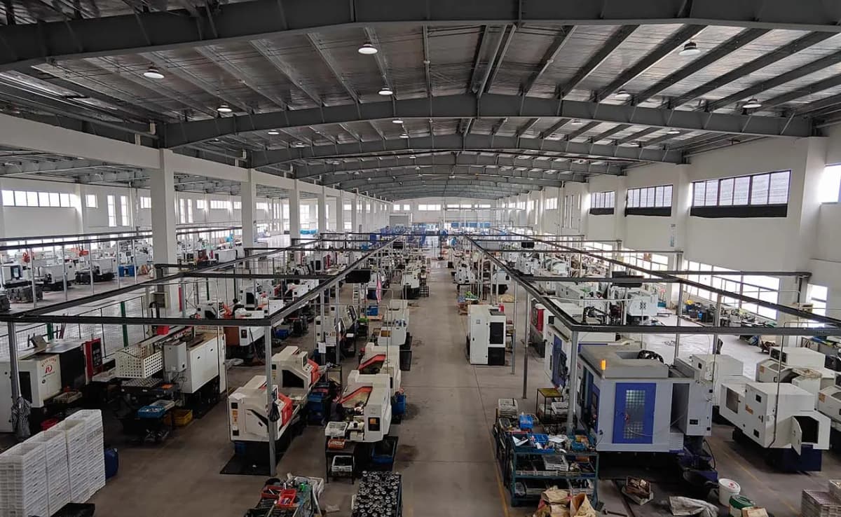 Factory floor with stamping presses and metal fabrication equipment.